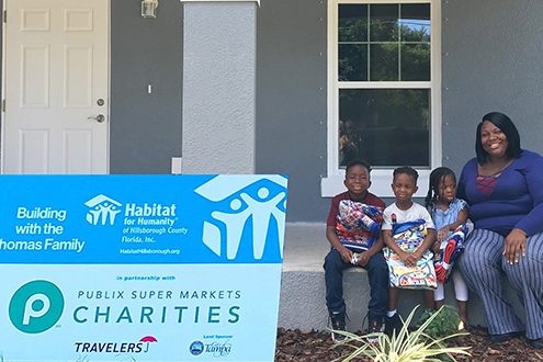 Raising the roof on the first of two Habitat-Thrivent Faith Build homes